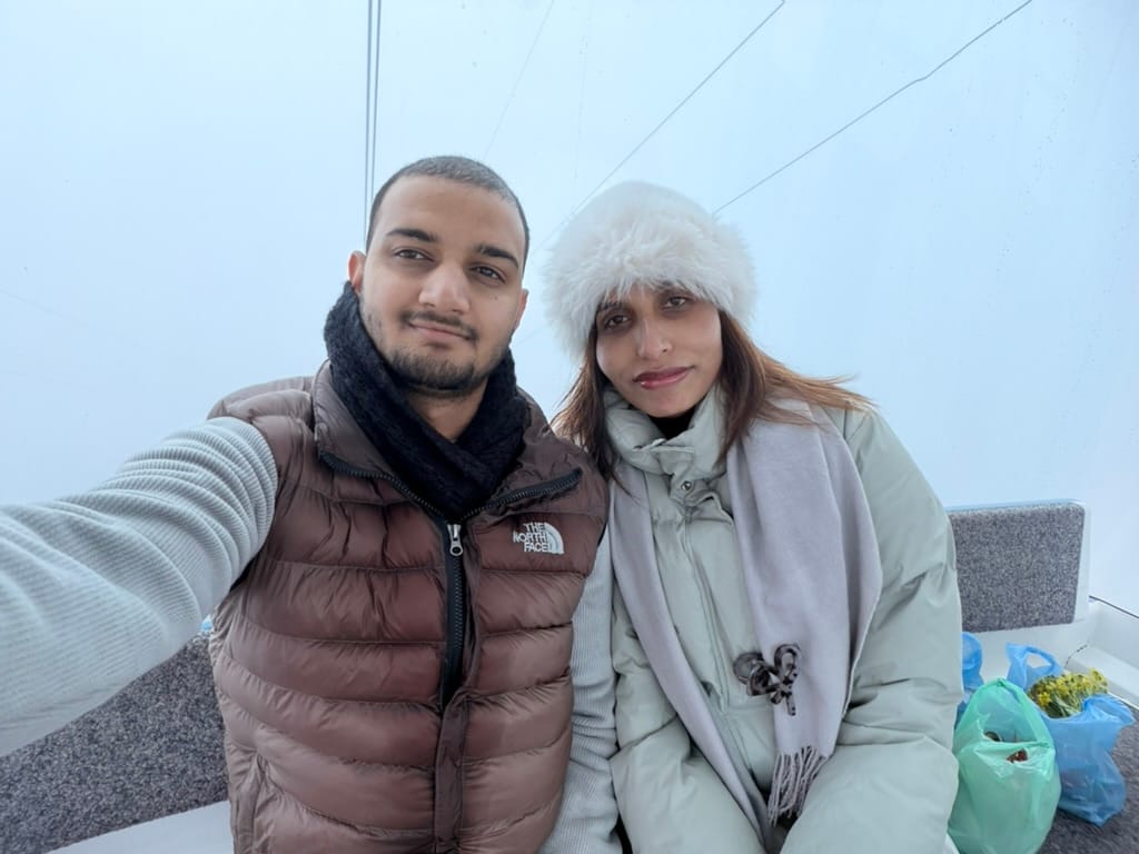 Inside the cable car, inside a cloud. Blue roofs where the mountains should have been.